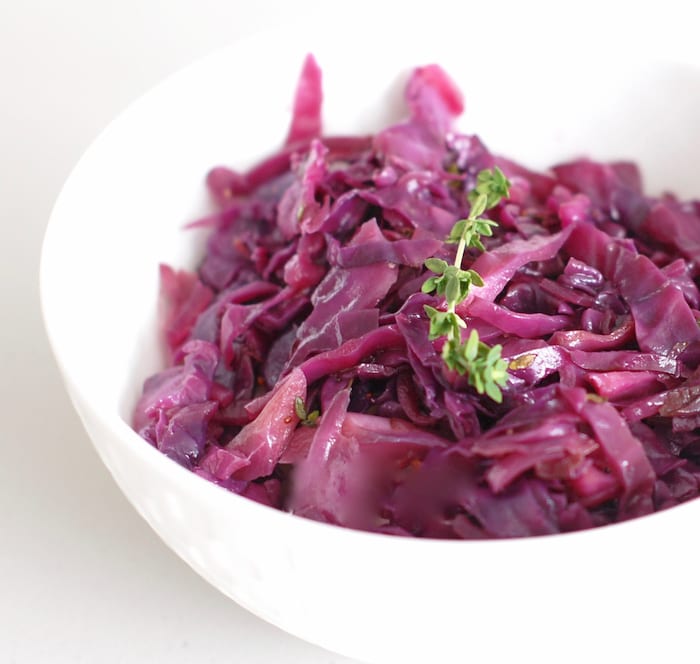 braised red cabbage and apples side dish close up side view of braised red cabbage and apples