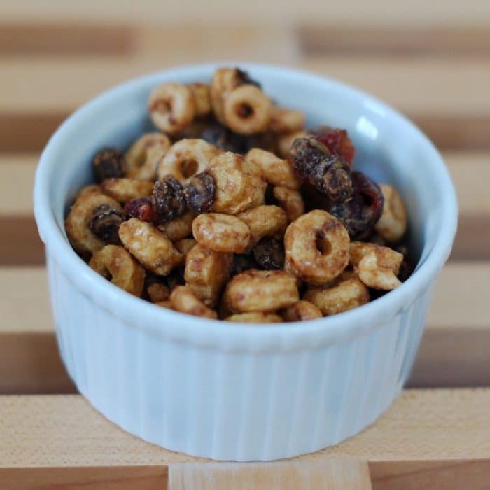 This Cranberry-Chocolate Peanut Butter Trail Mix Recipe is the perfect healthy travel snack or treat for all ages! Full recipe at JessicaLevinson.com #healthytrailmixrecipe #healthytravelsnacks #peanutbuttertrailmix Healthy Peanut Butter Trail Mix in White Dish