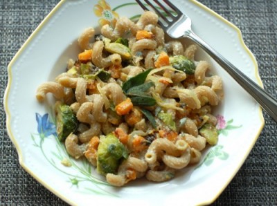 Roasted butternut squash and brussels sprouts tossed with creamy lemon-sage ricotta and a hint of maple syrup make this pasta dish nutritious and delicious, perfect for a cool fall night. Get the full recipe via JessicaLevinson.com #FallPasta #NationalPastaMonth #FallPastaRecipe Roasted Butternut Squash Pasta on Plate
