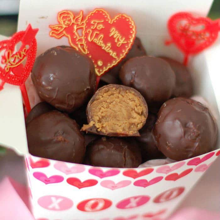 Rich & creamy chocolate peanut butter truffles are a decadent treat made healthier with Greek yogurt, maple syrup, natural peanut butter, & dark chocolate. Get the vegetarian and gluten-free recipe at JessicaLevinson.com | #ValentinesDayRecipes #HealthierDesserts #PeanutButterTruffles Valentine's Day Chocolate Peanut Butter Truffles