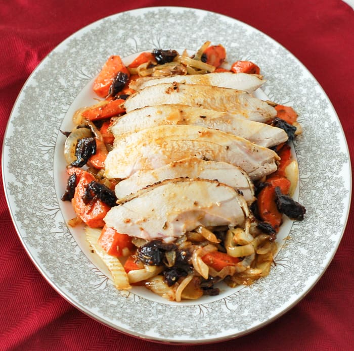 Juicy, savory, and flavorful roasted chicken with fennel, carrots, onions, and dried plums is easy enough for a weeknight meal and elegant enough for company. Also a great recipe for leftovers - if there are any! Get the gluten-free and dairy-free recipe via JessicaLevinson.com #RoastedChickenRecipe #EasyChickenRecipe Roasted Chicken with Fennel on Plate Overhead