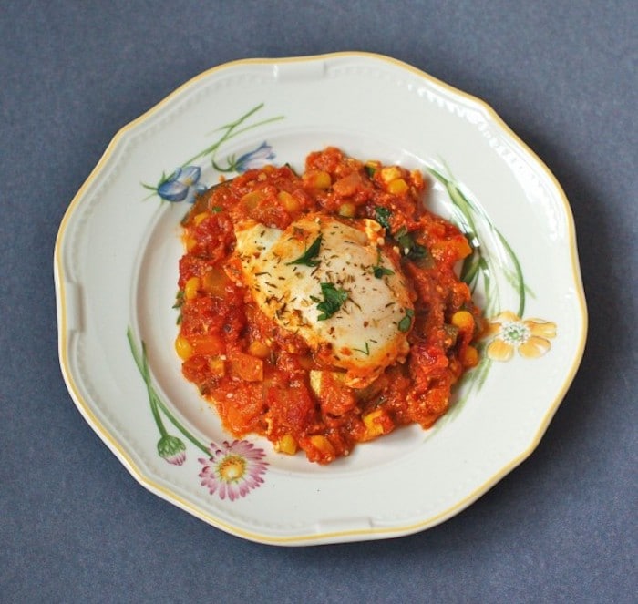 Summer Shakshuka | This summery twist on the classic Israeli breakfast recipe is an easy one-skillet dish of sautéed bell peppers, summer squash, corn, onions, and garlic in a Mediterranean-spiced tomato sauce with poached eggs and feta cheese. Get the gluten-free, vegetarian recipe via JessicaLevinson.com #EasySummerRecipes #ShakshukaRecipe. Summer Shakshuka Recipe on Plate Overhead