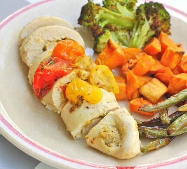 These Pistachio-Stuffed Chicken Breasts are filled with creamy pistachio mustard with a hint of lemon. An easy weeknight meal that will please the whole family. Get the gluten-free and dairy-free recipe via JessicaLevinson.com | #PistachioStuffedChicken #StuffedChickenRecipe Pistachio-Stuffed Chicken on Plate