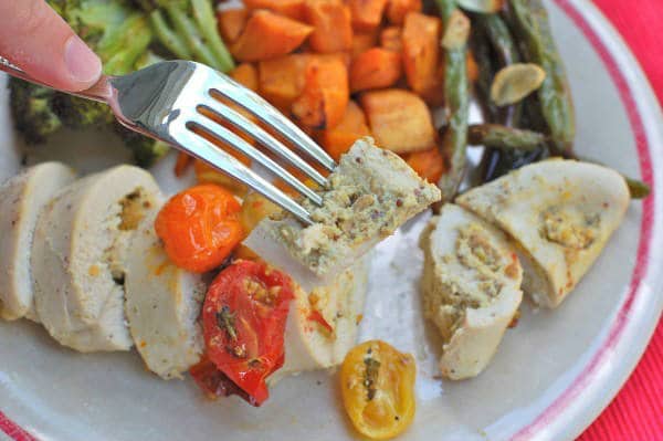 These Pistachio-Stuffed Chicken Breasts are filled with creamy pistachio mustard with a hint of lemon. An easy weeknight meal that will please the whole family. Get the gluten-free and dairy-free recipe via JessicaLevinson.com | #PistachioStuffedChicken #StuffedChickenRecipe Pistachio-Stuffed Chicken on Fork