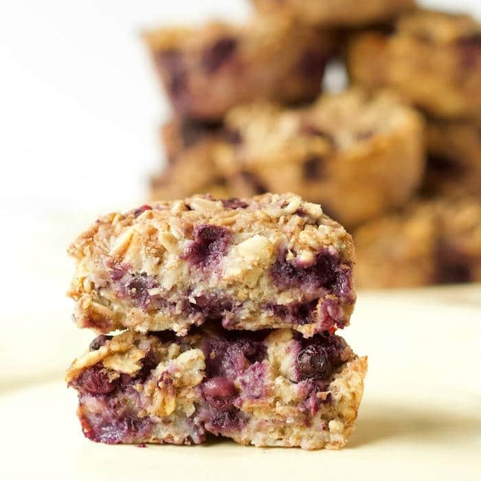 Ricotta Berry Oatmeal Cups | Whole grain oatmeal cups are studded with wild blueberries and full of low-fat dairy and warming spices. A good source of protein, fiber, and calcium, making them the perfect way to start the day! Get the gluten-free, egg-free, vegetarian recipe via JessicaLevinson.com #OatmealCups #EggFreeBreakfast #GlutenFreeOatmeal Ricotta Berry Oatmeal Cups Stacked
