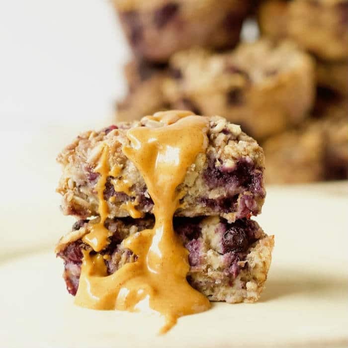 Ricotta Berry Oatmeal Cups | Whole grain oatmeal cups are studded with wild blueberries and full of low-fat dairy and warming spices. A good source of protein, fiber, and calcium, making them the perfect way to start the day! Get the gluten-free, egg-free, vegetarian recipe via JessicaLevinson.com #OatmealCups #EggFreeBreakfast #GlutenFreeOatmeal Ricotta Berry Oatmeal Cups with Peanut Butter
