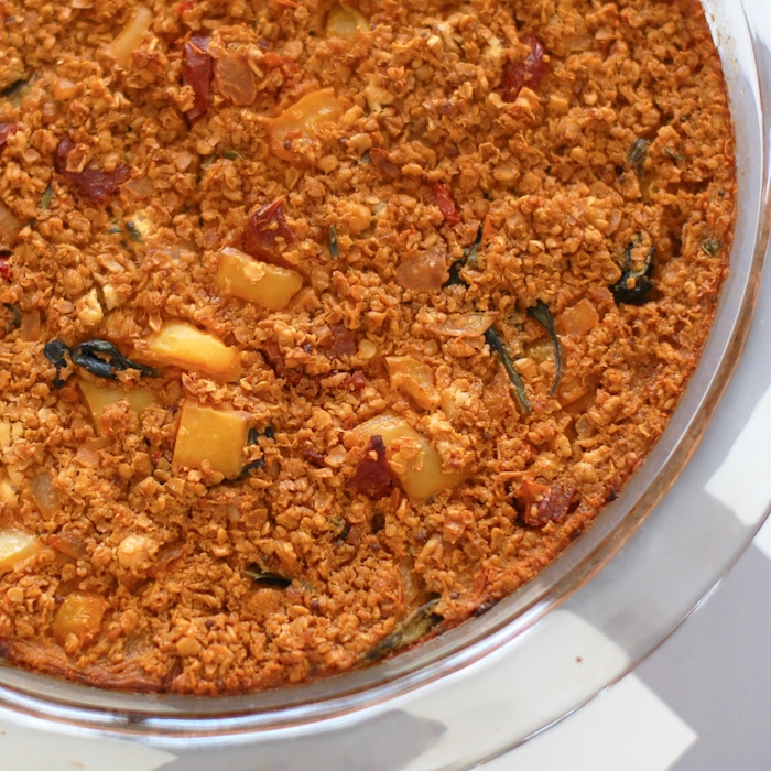 Heart-healthy oats are combined with sun-dried tomatoes, baby spinach, thyme, and creamy goat cheese in this savory baked oatmeal frittata. Recipe at JessicaLevinson.com | #GlutenFree #vegetarian #vegetarianrecipes #recipes #dinner #quickandeasy #frittata #oatmeal #savoryoats #bakedoatmeal savory baked oatmeal breakfast for dinner