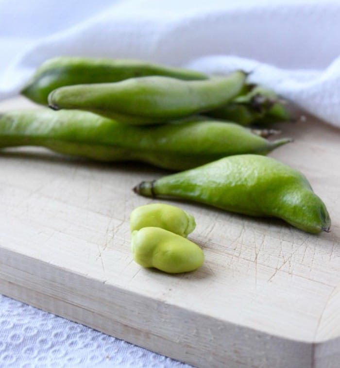 fresh fava beans Fresh Fava Beans in pods on cutting board