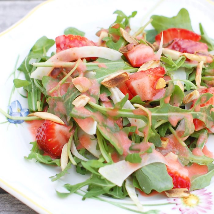 Strawberry Arugula Salad with Fennel, Toasted Almonds, and Strawberry Champagne Vinaigrette is a fresh and sweet salad for the spring and summer. Get the recipe via JessicaLevinson.com #StrawberrySaladRecipe #ArugulaSalad Strawberry Arugula Salad with Fennel, Toasted Almonds, and Strawberry Champagne Vinaigrette is a fresh and sweet salad for the spring and summer. Via JessicaLevinson.com | #salad #strawberries #glutenfree #vegetarian #veganfriendly #dairyfree