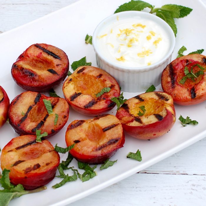 Grilled Stone Fruit with Honey Lemon Yogurt Sauce is a naturally delicious, low-calorie, vegetarian and gluten-free way to end to your summer BBQ. Get the recipe at JessicaLevinson.com | #GrilledFruit #StoneFruitRecipes Grilled Stone Fruit on Platter with Yogurt Sauce
