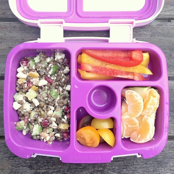 Lentil Chickpea Vegetable Salad with Feta | Protein and fiber-rich lentils and chickpeas, crunchy bell peppers and Persian cucumbers, sweet pomegranate seeds, and salty feta cheese are tossed together in a lemony maple-mustard vinaigrette for a kid-friendly and adult approved lunchbox salad. Get this gluten-free, nut-free, vegetarian, and vegan-friendly recipe via JessicaLevinson.com #LentilSaladRecipe #VegetarianLentilSalad Lentil Chickpea Vegetable Salad in Lunchbox