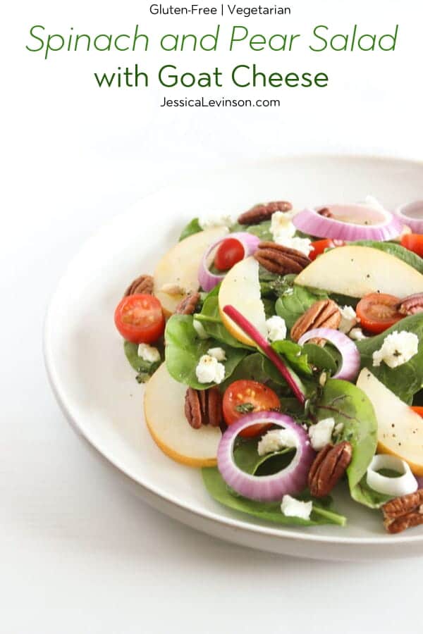 Spinach Pear Salad with Goat Cheese and Lemon Thyme Vinaigrette | There's nothing boring about this flavor-packed salad! A bed of baby spinach is topped with crisp pears, juicy tomatoes, crunchy red onions and pecans, and creamy goat cheese, and tossed in a bright and aromatic lemon thyme vinaigrette. Get the full vegetarian and gluten-free recipe via JessicaLevinson.com #SpinachSaladwithGoatCheese #EasySpinachSalad Spinach and Pear Salad with Goat Cheese with Text Overlay