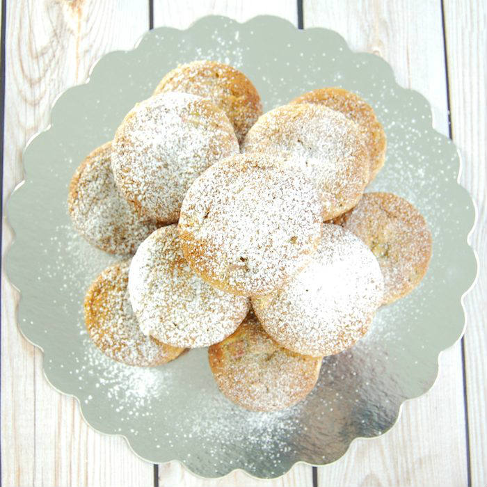 Rhubarb Ginger Lemon Muffins ready to serve Rhubarb Ginger Lemon Muffins dusted with powdered sugar and Stacked on Dish