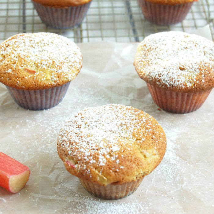 Rhubarb Ginger Lemon Muffins dusted with powdered sugar Rhubarb Ginger Lemon Muffins on parchment paper with Powdered Sugar