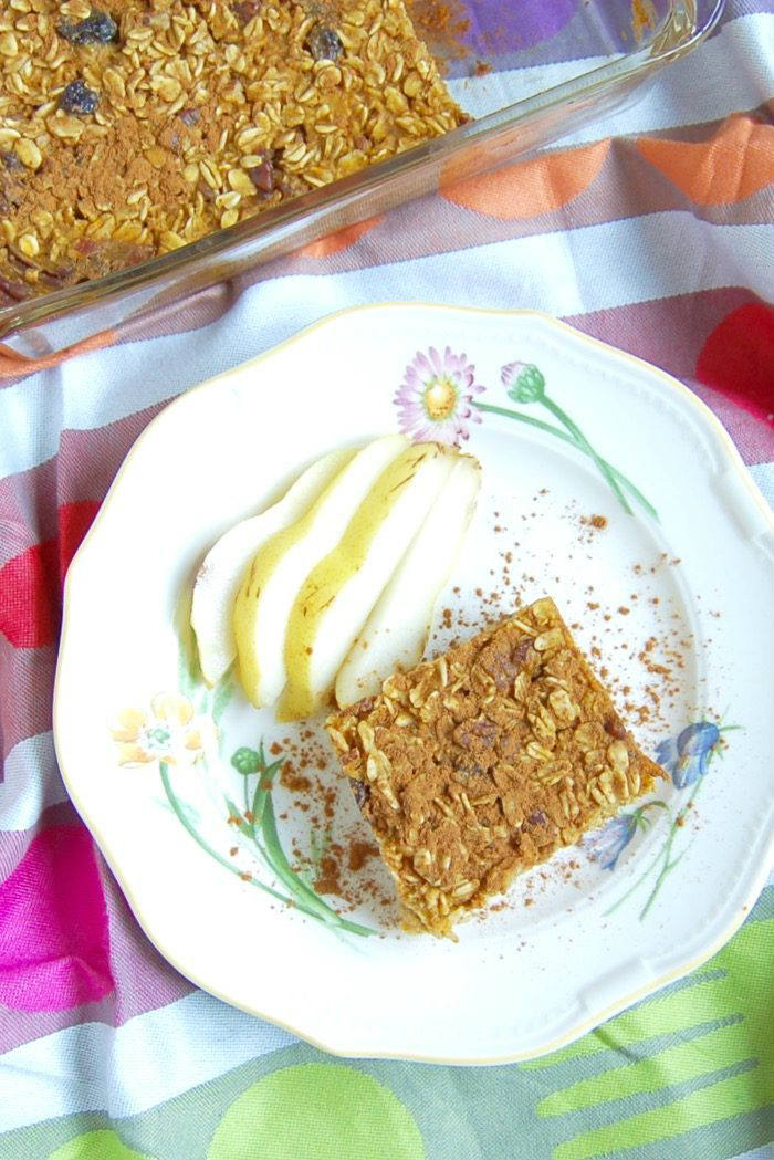 Forget about the PSL! A piece of this pumpkin spice baked oatmeal with pecans and raisins is all you need for breakfast this fall! Recipe via JessicaLevinson.com | #PumpkinOatmealRecipe #MakeAheadBreakfast #BakedOatmealRecipe Pumpkin Spice Baked Oatmeal on Plate