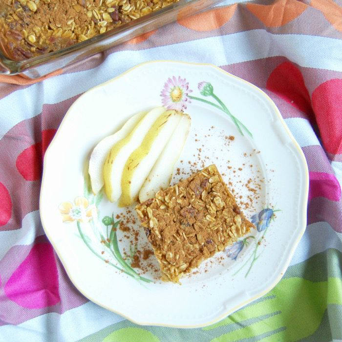 Forget about the PSL! A piece of this pumpkin spice baked oatmeal with pecans and raisins is all you need for breakfast this fall! Recipe via JessicaLevinson.com | #PumpkinOatmealRecipe #MakeAheadBreakfast #BakedOatmealRecipe Pumpkin Spice Baked Oatmeal Recipe on Plate