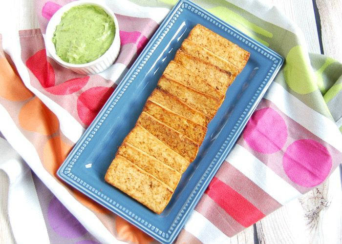 Grilled tofu Grilled Tofu on blue serving plate with avocado sauce in ramekin on side