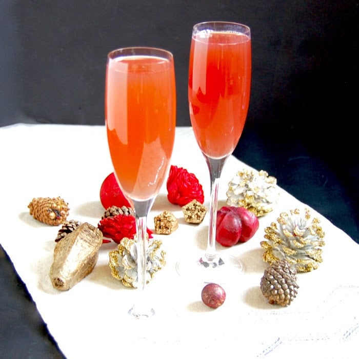 Celebrate the holiday season and ring in the New Year with a bright and festive Pomegranate French 75 cocktail with less added sugar. Recipe via JessicaLevinson.com #AD #ChampagneCocktail #NewYearsCocktail #CocktailRecipe Pomegranate French 75 Cocktails