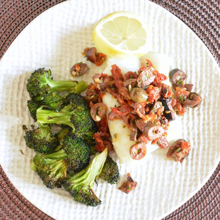 Oven Baked Cod with Rustic Sun Dried Tomato Olive Tapenade | Jessica Levinson, MS, RDN, CDN close up of plated Oven Baked Cod with Rustic Sun Dried Tomato Olive Tapenade